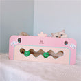 Charger l'image dans la visionneuse de la galerie, Cat peeking from inside pink corrugated cat scratcher bed with two green balls in front