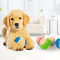 Load image into Gallery viewer, Golden retriever puppy lying indoors holding blue and beige textured chew ball