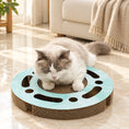 Cargar la imagen en la vista de la galería, Round mint corrugated cat scratcher with a cat resting on the centre in a cream living room
