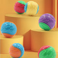 Load image into Gallery viewer, Group of colorful bite-resistant rubber dog toy balls displayed on yellow steps with an orange background