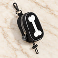 Cargar la imagen en la vista de la galería, Black bone-design waste-bag pouch with white bone motif, clip and toggle loop