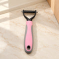 Cargar la imagen en la vista de la galería, Pink and grey double-sided grooming comb, small head, on beige marble