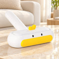 Load image into Gallery viewer, White duck-shaped pet hair removal brush with yellow beak and white handle on ivory marble