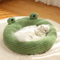 Load image into Gallery viewer, Green knitted frog-shaped pet bed with cat peacefully sleeping inside on a soft rug