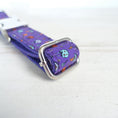Load image into Gallery viewer, Detailed view of collar adjustment strap with Halloween-themed purple fabric and metal slide buckle
