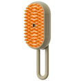 Cargar la imagen en la vista de la galería, Beige electric pet brush front view highlighting orange soft silicone bristles