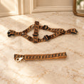 Load image into Gallery viewer, Tan and black Greek key dog harness and matching leash on beige marble