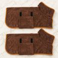 Load image into Gallery viewer, Two coffee brown dog drying robes with orange trim on ivory marble