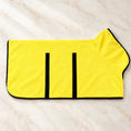 Load image into Gallery viewer, Yellow dog drying robe with black trim and fastening strips on ivory marble
