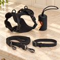 Charger l'image dans la visionneuse de la galerie, Black dog harness, collar, lead and bag holder arranged on beige marble