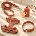 Charger l'image dans la visionneuse de la galerie, Brown dog harness, collar, lead and bag holder arranged on beige marble