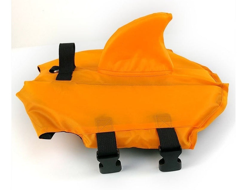 Orange shark fin dog life jacket laid flat showing buckle straps and design details