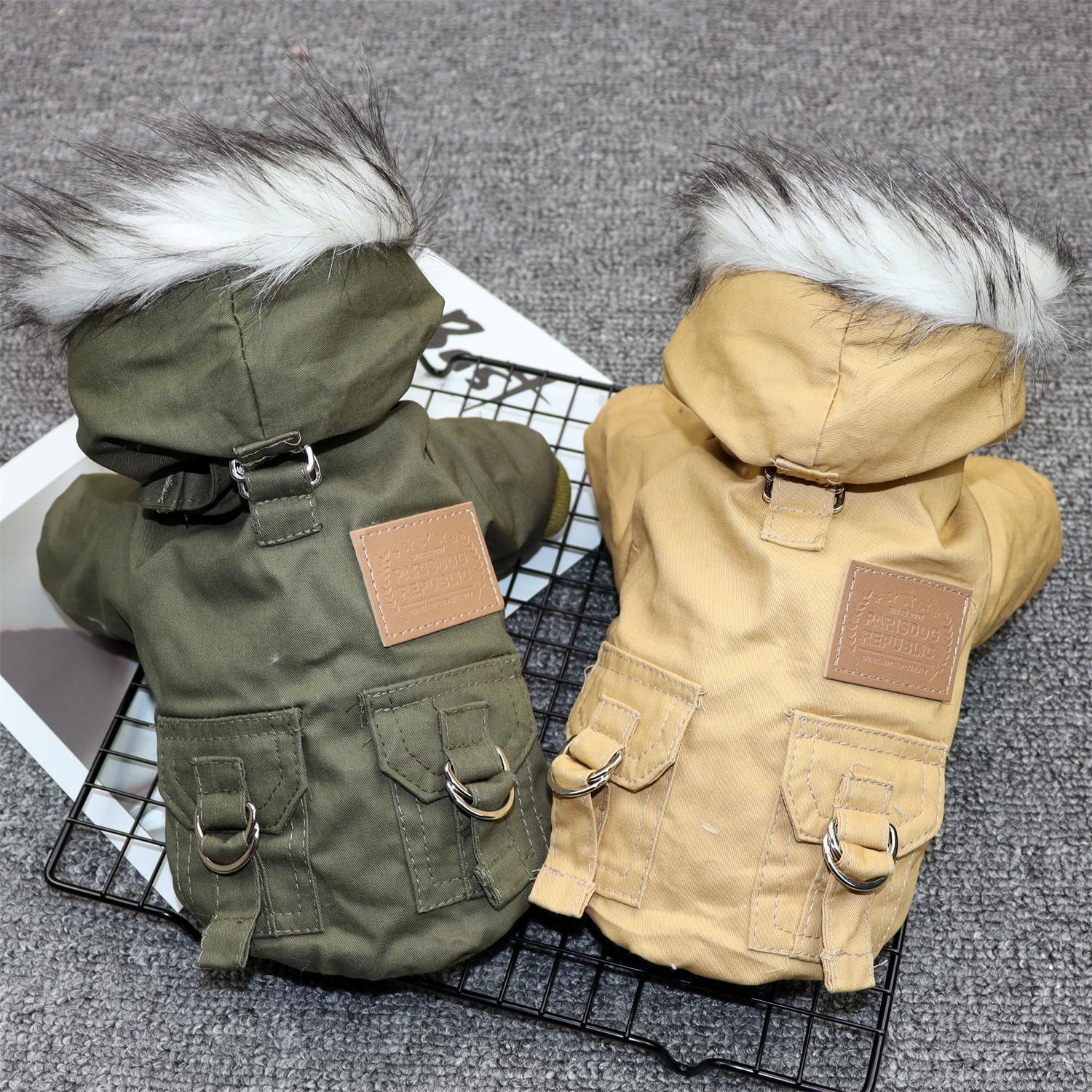 Two winter dog coats in olive green and khaki side by side, showcasing fur-trimmed hoods and buckle pocket details