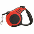Cargar la imagen en la vista de la galería, Close-up side view of red automatic retractable dog leash showing ergonomic handle and locking buttons

