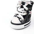 Load image into Gallery viewer, Close-up angled view of black and white star print dog shoe with white padded interior
