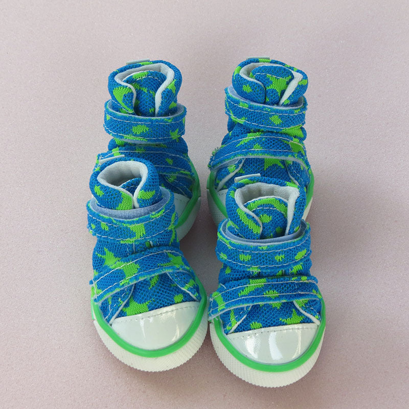 Pair of blue star-patterned high-top dog sneakers viewed from front on light background.