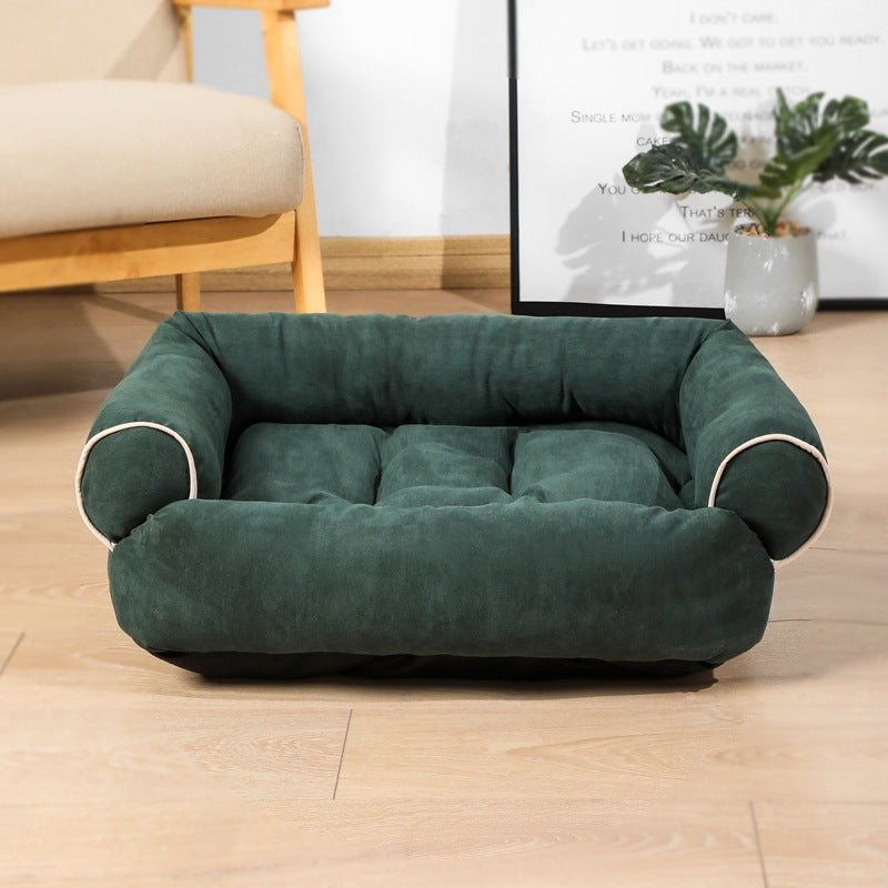 Deep forest green velvet pet sofa bed with soft cushioned edges and piping detail