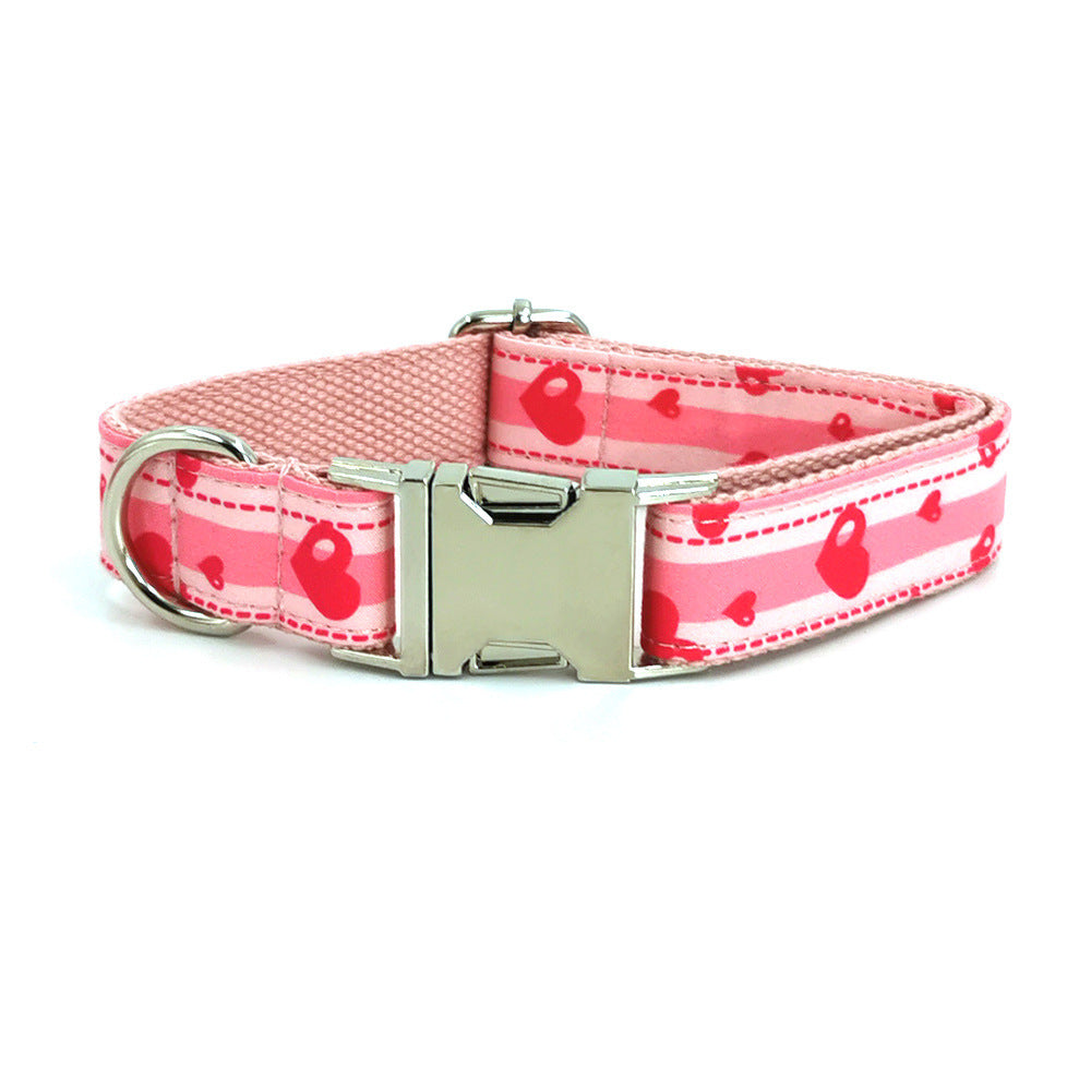 Pink dog collar with metal buckle and D-ring showing red heart design
