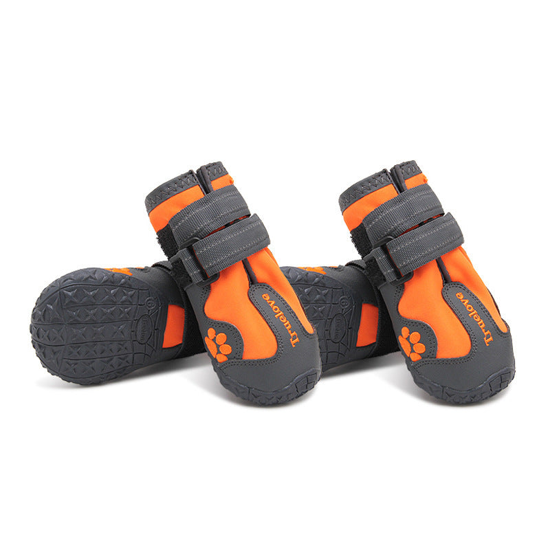 Pair of orange and gray waterproof dog shoes with velcro straps displayed on white background
