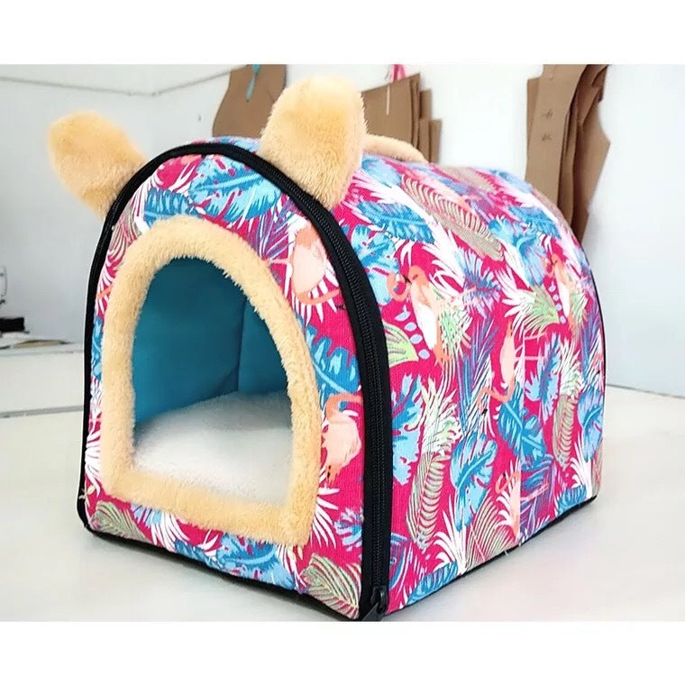 Pink flamingo and leaf patterned plush pet kennel with yellow ears on white background