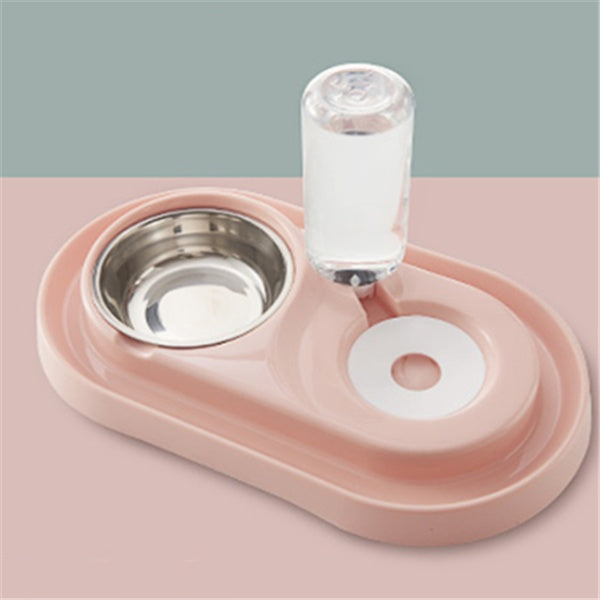 Pink automatic pet feeding station with stainless steel bowl and water bottle on pink surface