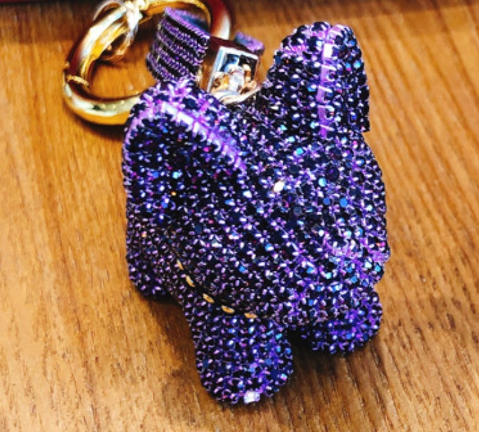 Purple crystal dog keychain with sparkling detail displayed on a wooden table showcasing color vibrancy and shine