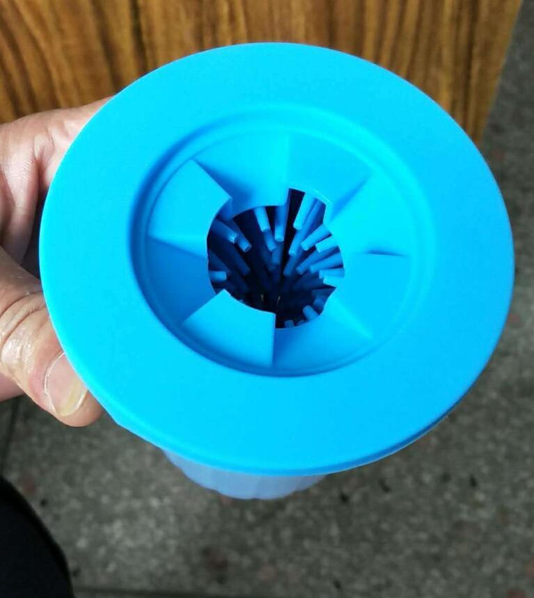 Top view of blue silicone washer showing cleaning opening and bristles