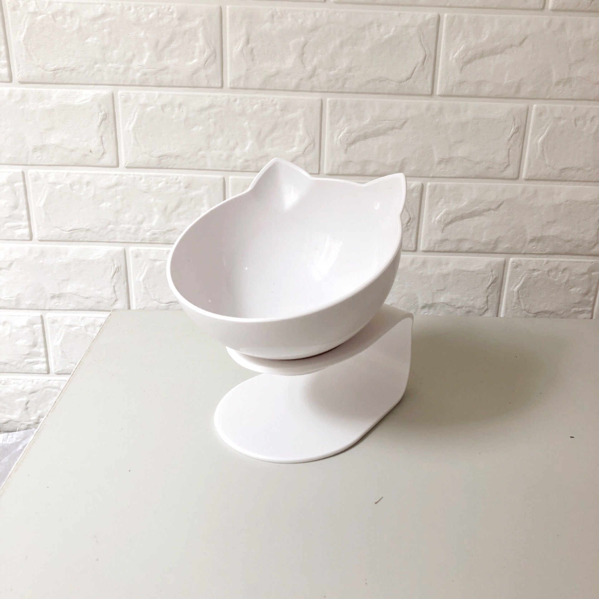 Close-up of clear cat ear bowl with pink base