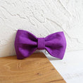 Load image into Gallery viewer, Close-up of purple velvet dog bow tie on wood and white textured background.
