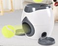 Load image into Gallery viewer, White and gray feeder with tennis balls shown rolling out of the machine
