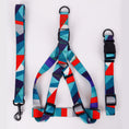 Load image into Gallery viewer, Blue and red geometric dog harness standing upright on white background
