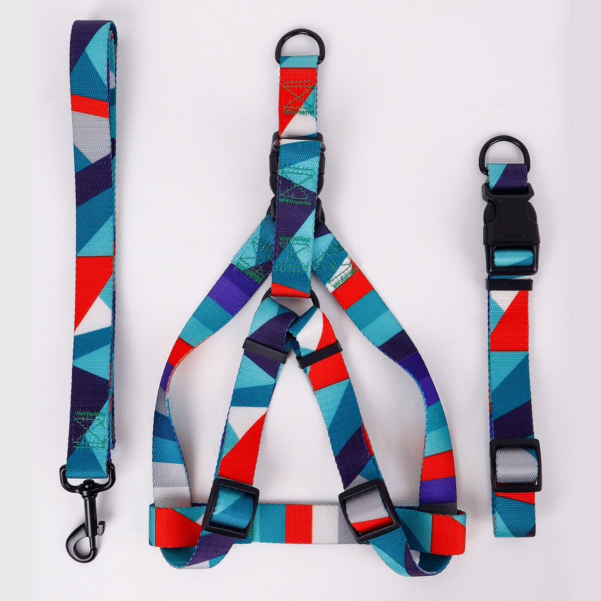 Blue and red geometric dog harness standing upright on white background