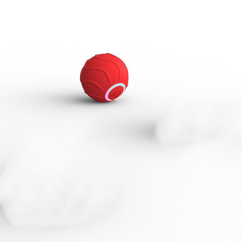 Red cat toy ball bouncing on white surface