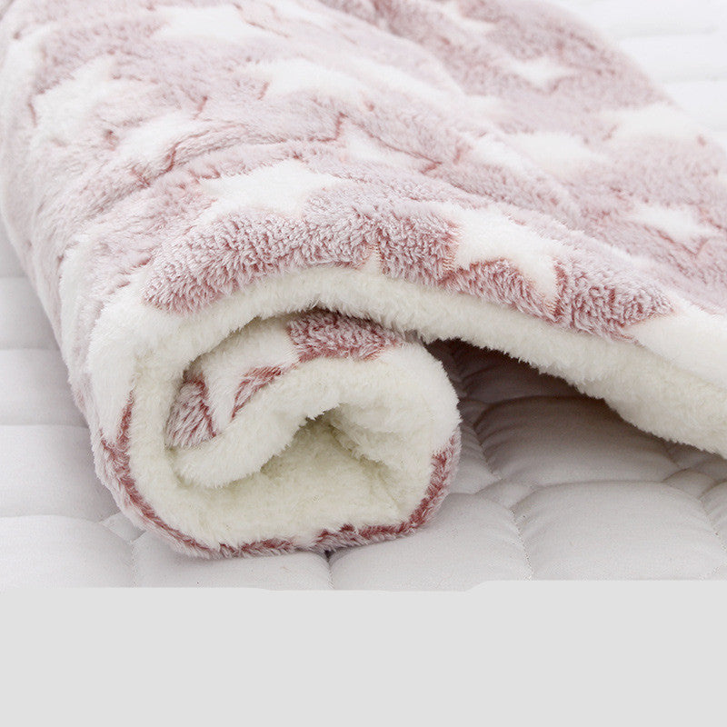 Rolled plush pet blanket with light pink star pattern and white fleece backing