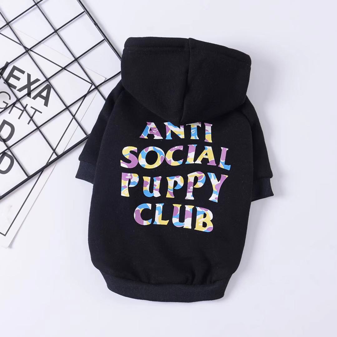 Black plush hooded dog sweater with colorful ANTI SOCIAL PUPPY CLUB print laid flat