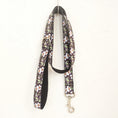 Load image into Gallery viewer, Matching floral dog leash hanging against a textured white wall
