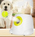 Load image into Gallery viewer, White automatic ball launcher with yellow-green launching opening beside happy golden retriever catching a tennis ball indoors
