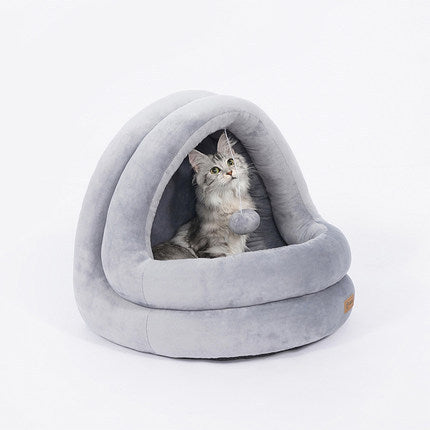 Light gray plush pet cave bed on white background featuring a cat inside playing with the hanging plush ball toy