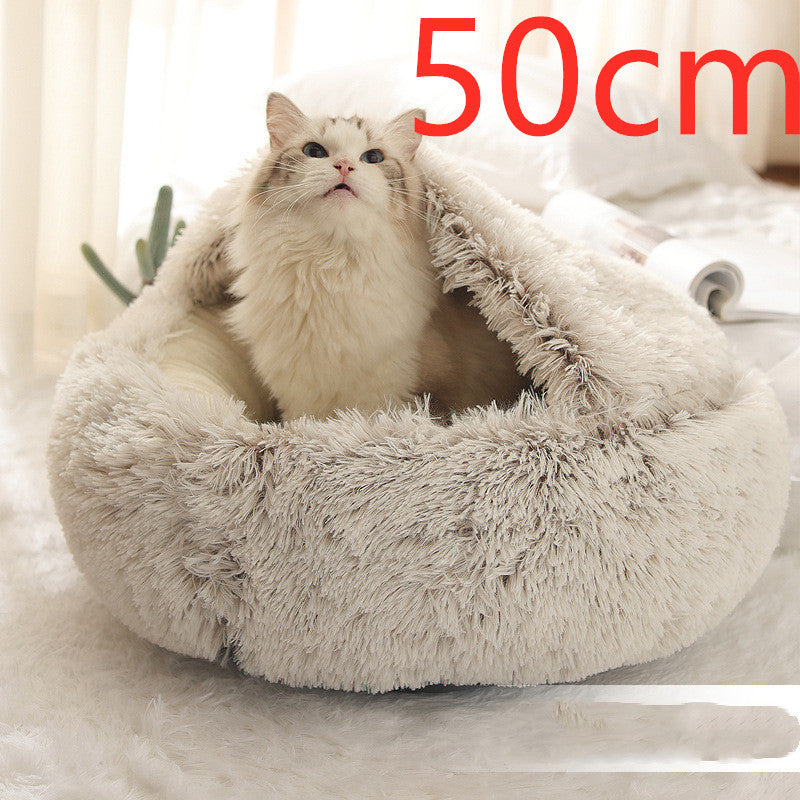Cat sitting inside beige plush dome bed labeled 50 cm size