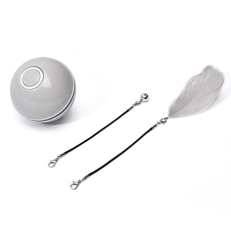 Grey LED light cat toy ball with detachable black string attachments including a grey feather and a bell on white background