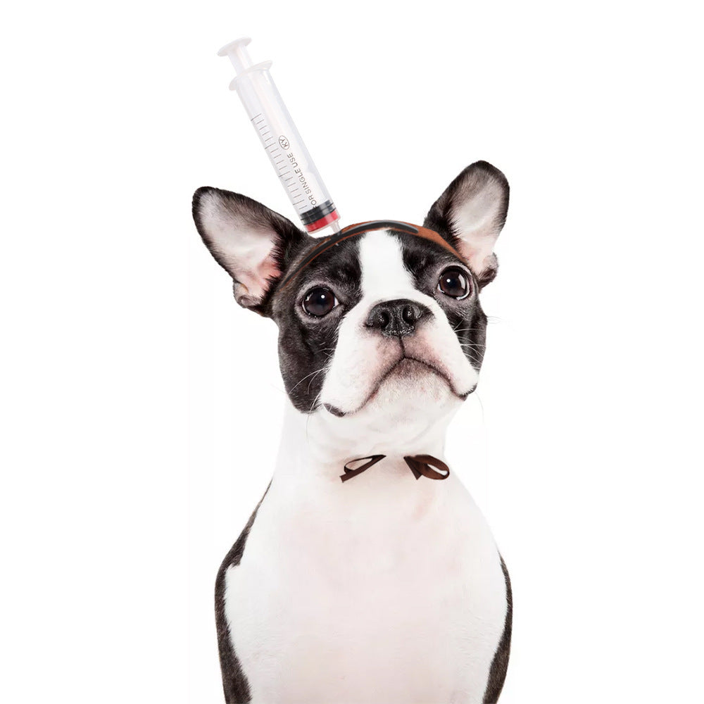 Fawn pug wearing bloody hammer headgear with tongue out
