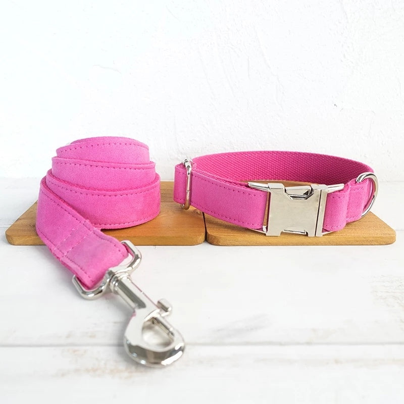 Pink velvet dog collar and leash set displayed side by side on wooden board