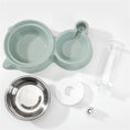 Cargar la imagen en la vista de la galería, Disassembled components of automatic pet feeding station showing plastic base, stainless steel bowl, water bottle, and refill parts
