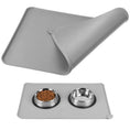 Cargar la imagen en la vista de la galería, Gray silicone pet feeding mat folded to show soft and flexible material  
