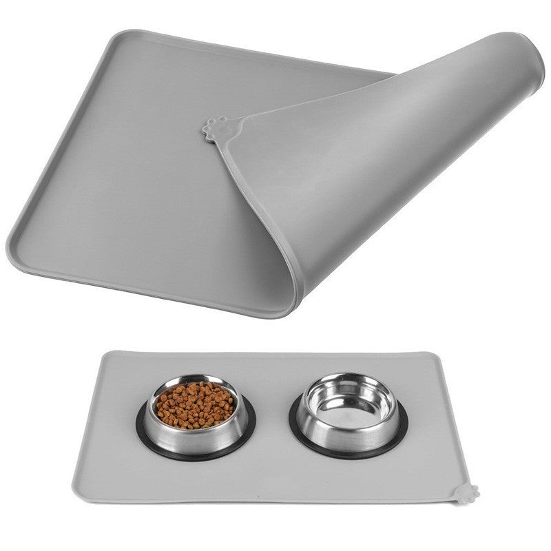 Gray silicone pet feeding mat folded to show soft and flexible material  