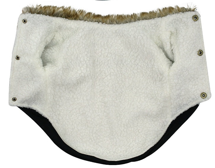 Inside view of dog jacket showing soft white lambskin fleece lining with snap buttons on edges