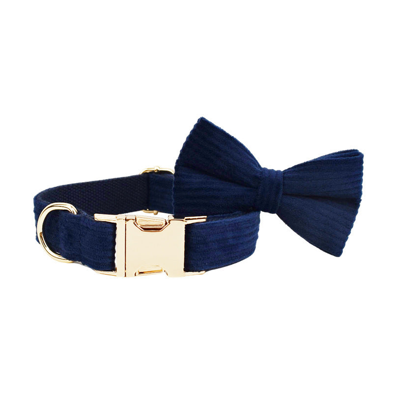 Navy blue corduroy dog collar with attached bow tie and gold buckle