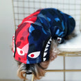Load image into Gallery viewer, Close-up of the hood on the dog’s camouflage color block hoodie showing graphic eyes and teeth design
