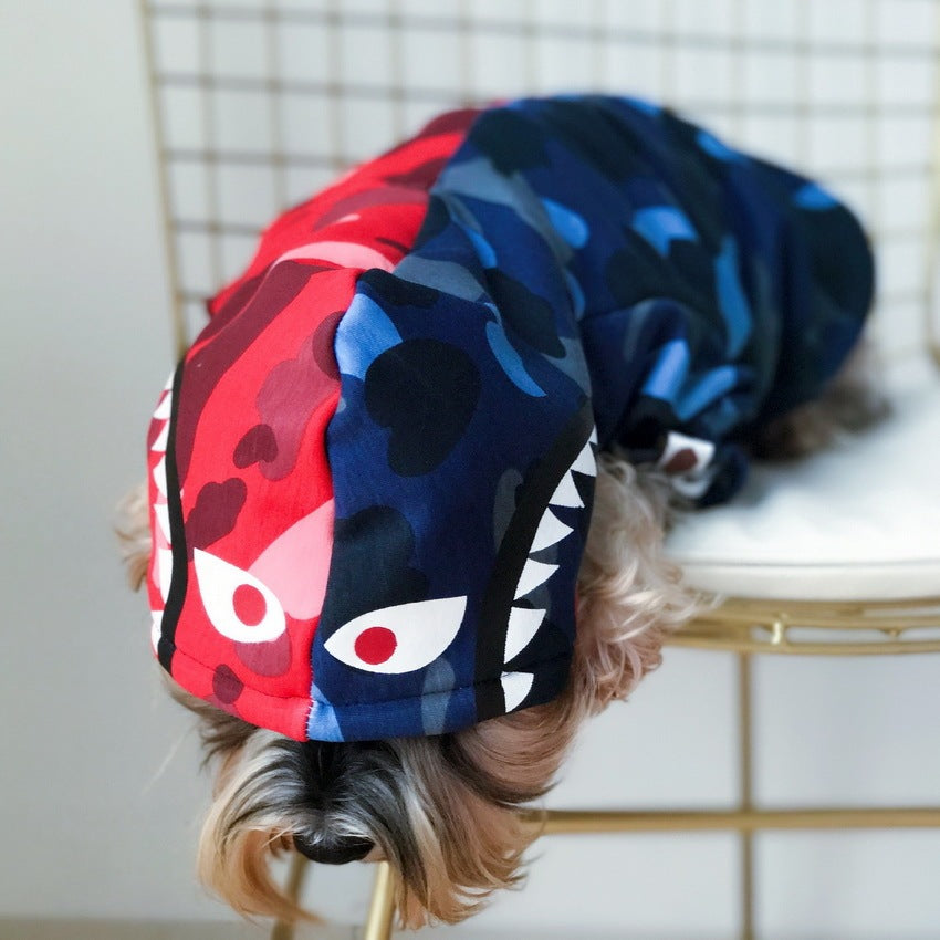 Close-up of the hood on the dog’s camouflage color block hoodie showing graphic eyes and teeth design