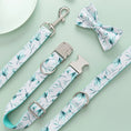 Load image into Gallery viewer, Close-up of leaf patterned leash, collar, and detachable bow tie on light green background
